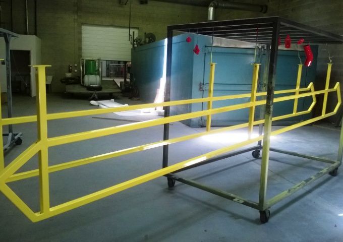 A yellow railing is sitting on a cart in a room