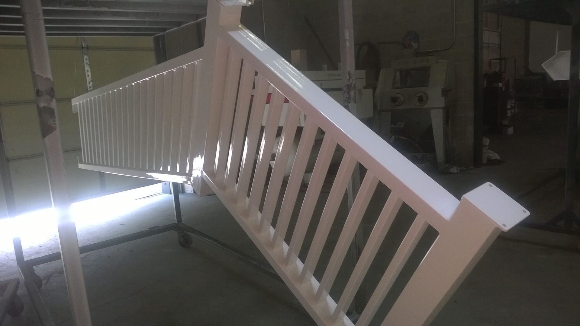 A white railing is sitting on a table in a room.