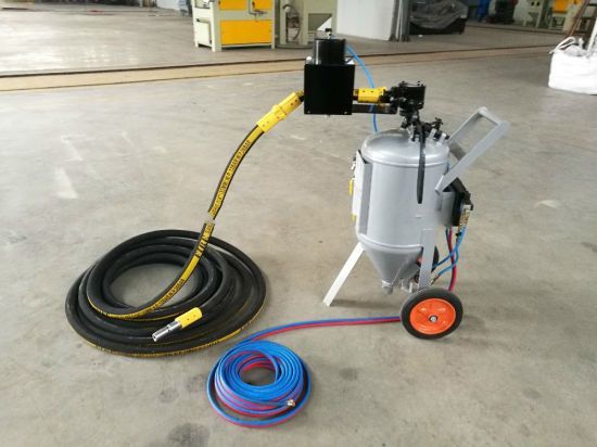 A sandblasting machine with a hose attached to it