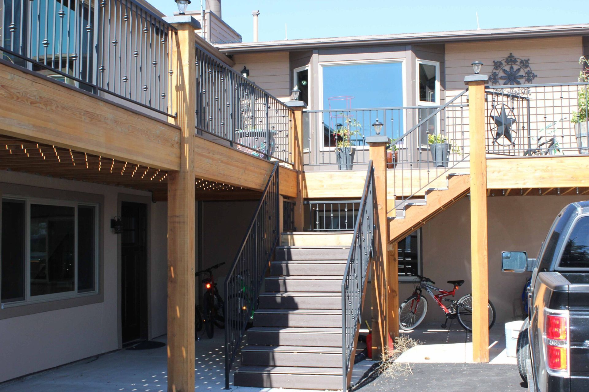 A truck is parked in front of a house with stairs leading up to it