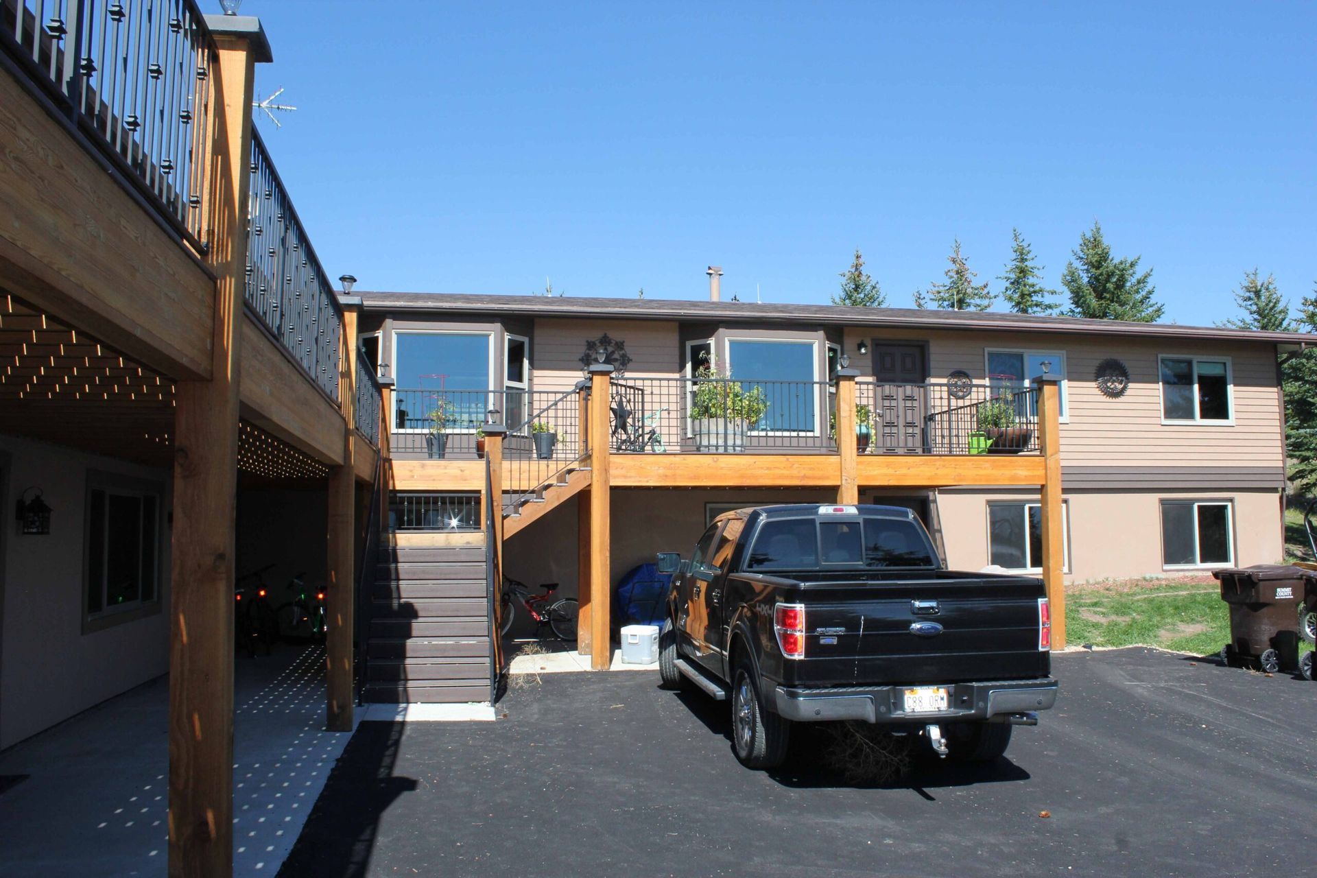 A black truck is parked in front of a house