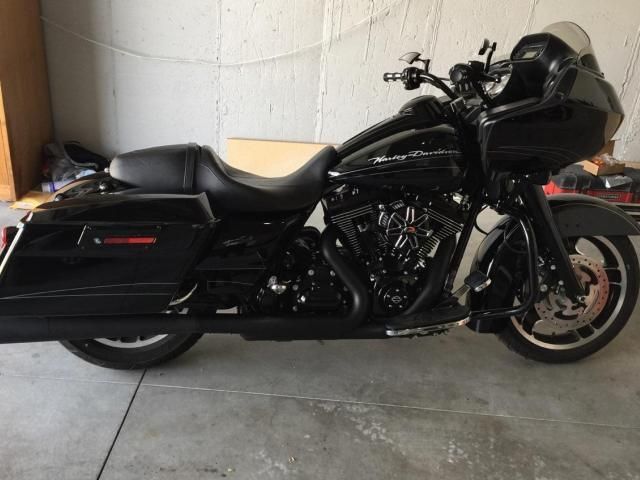 A black harley davidson motorcycle is parked in a garage.