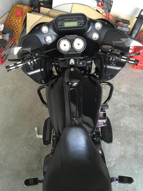 A black harley davidson motorcycle is parked in a garage