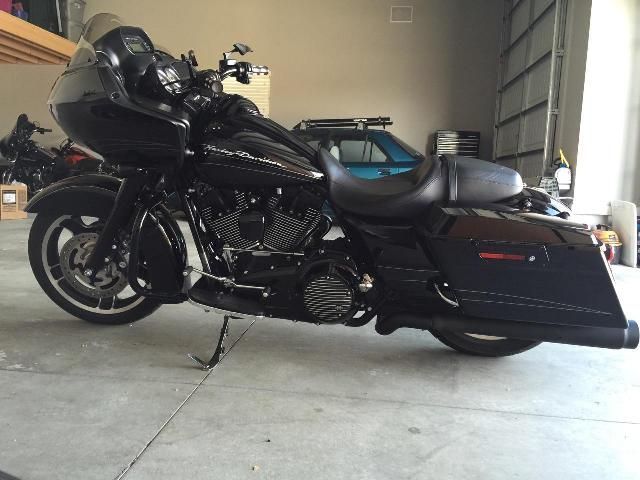 A black harley davidson motorcycle is parked in a garage