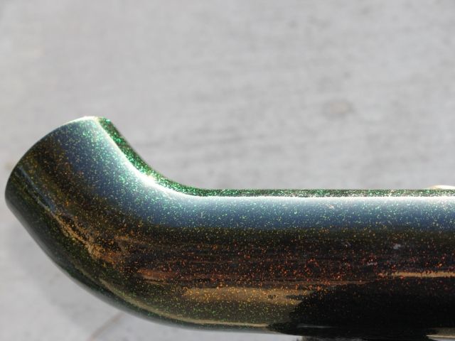 A close up of a green and black object on a table.