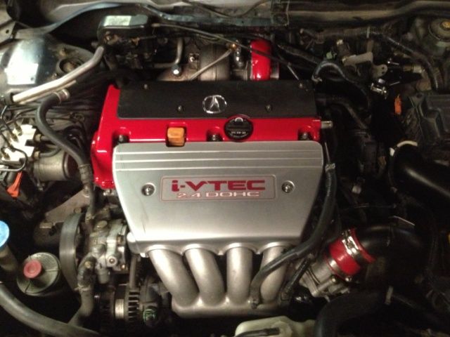 A close up of a car engine that says i-vtec