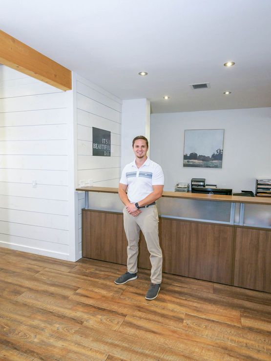 A man is standing in front of a counter in an office.