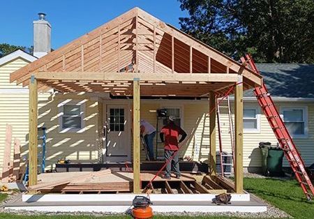 a wooden structure is being built on the side of a house
