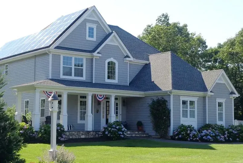 A large house with a solar panel on the roof