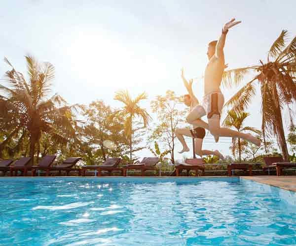 Kids Jumping Into Clean Pool — Holiday Coast Pools in Coffs Harbour, NSW