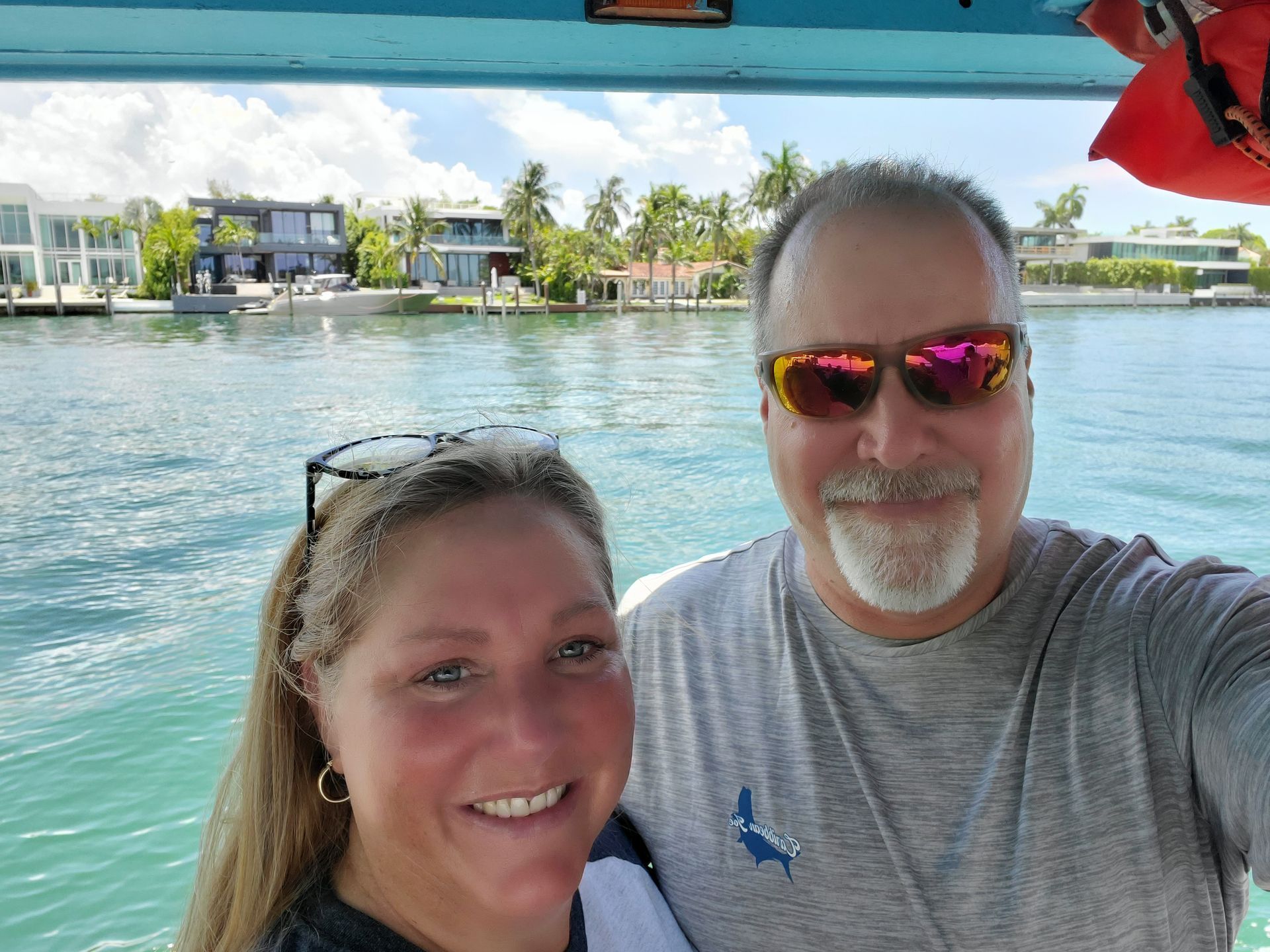 A man and a woman are posing for a picture on a boat