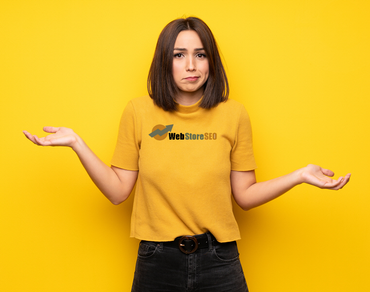 A woman wearing a yellow shirt that says web store seo shrugging her shoulders