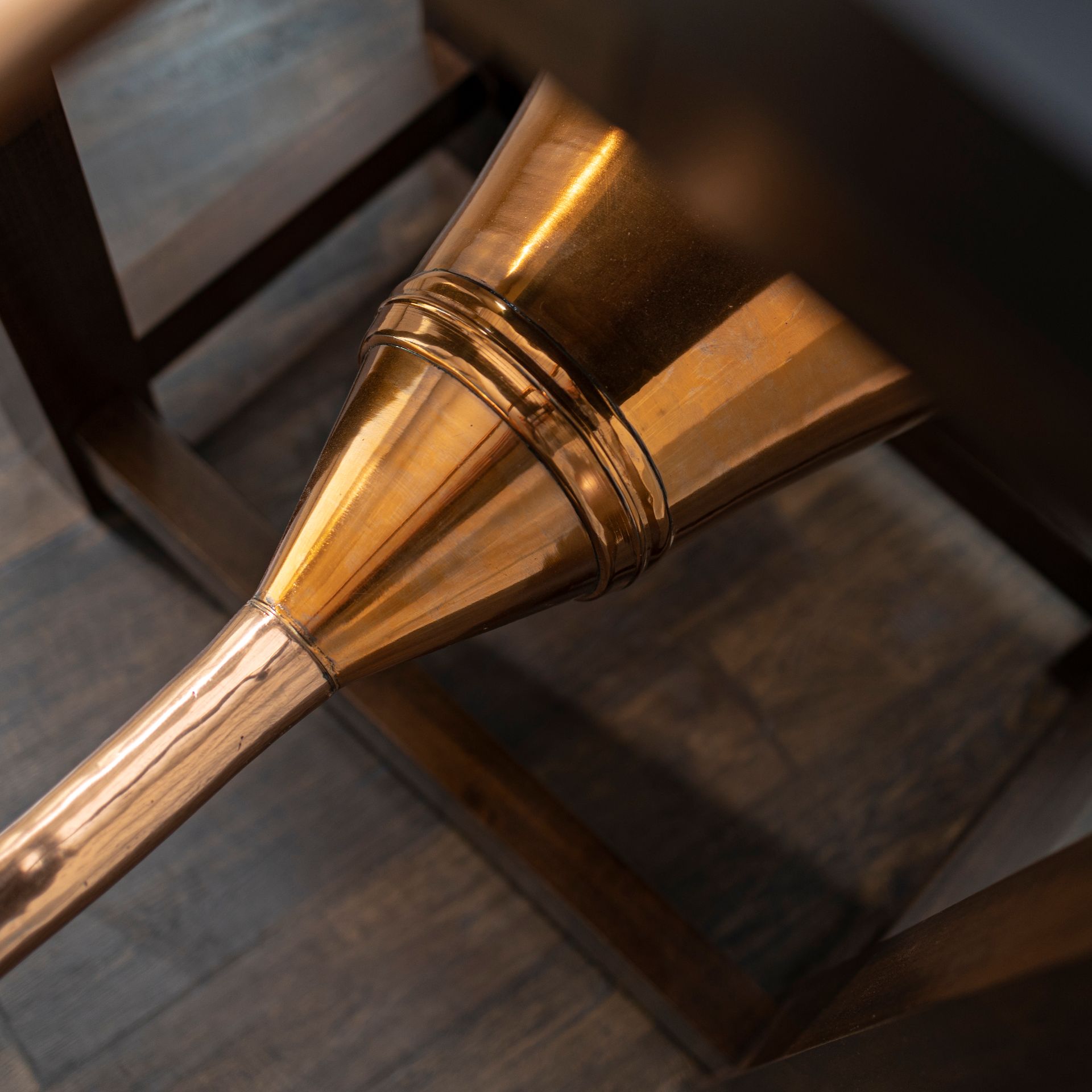 A brass object is sitting on a wooden table