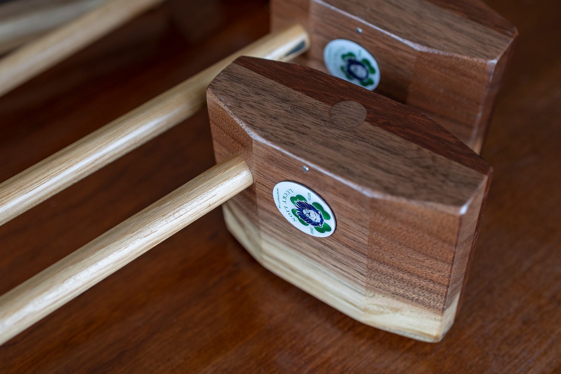 Two wooden rocking horses are sitting on a wooden table.
