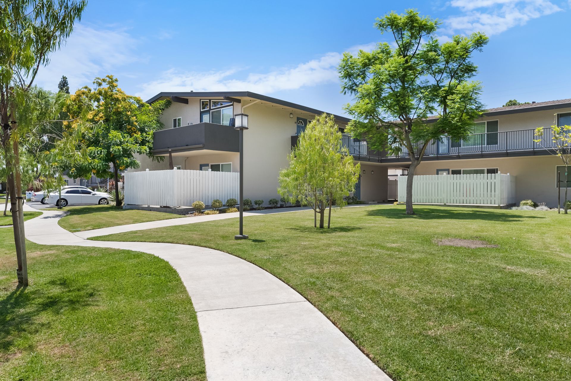 building exterior with sidewalk and grass field
