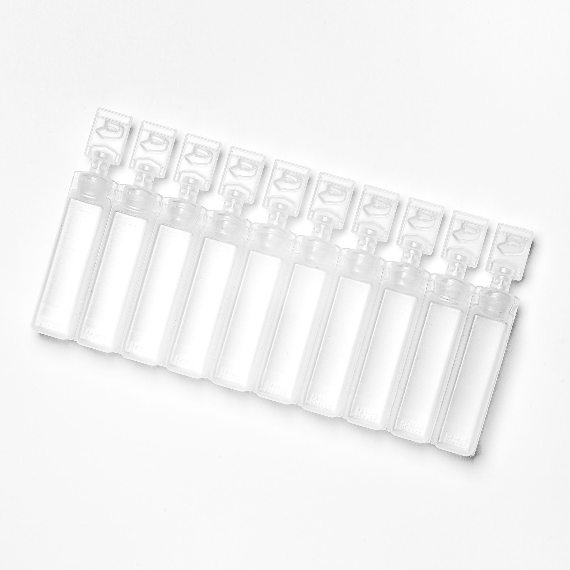 a row of empty plastic bottles on a white background .