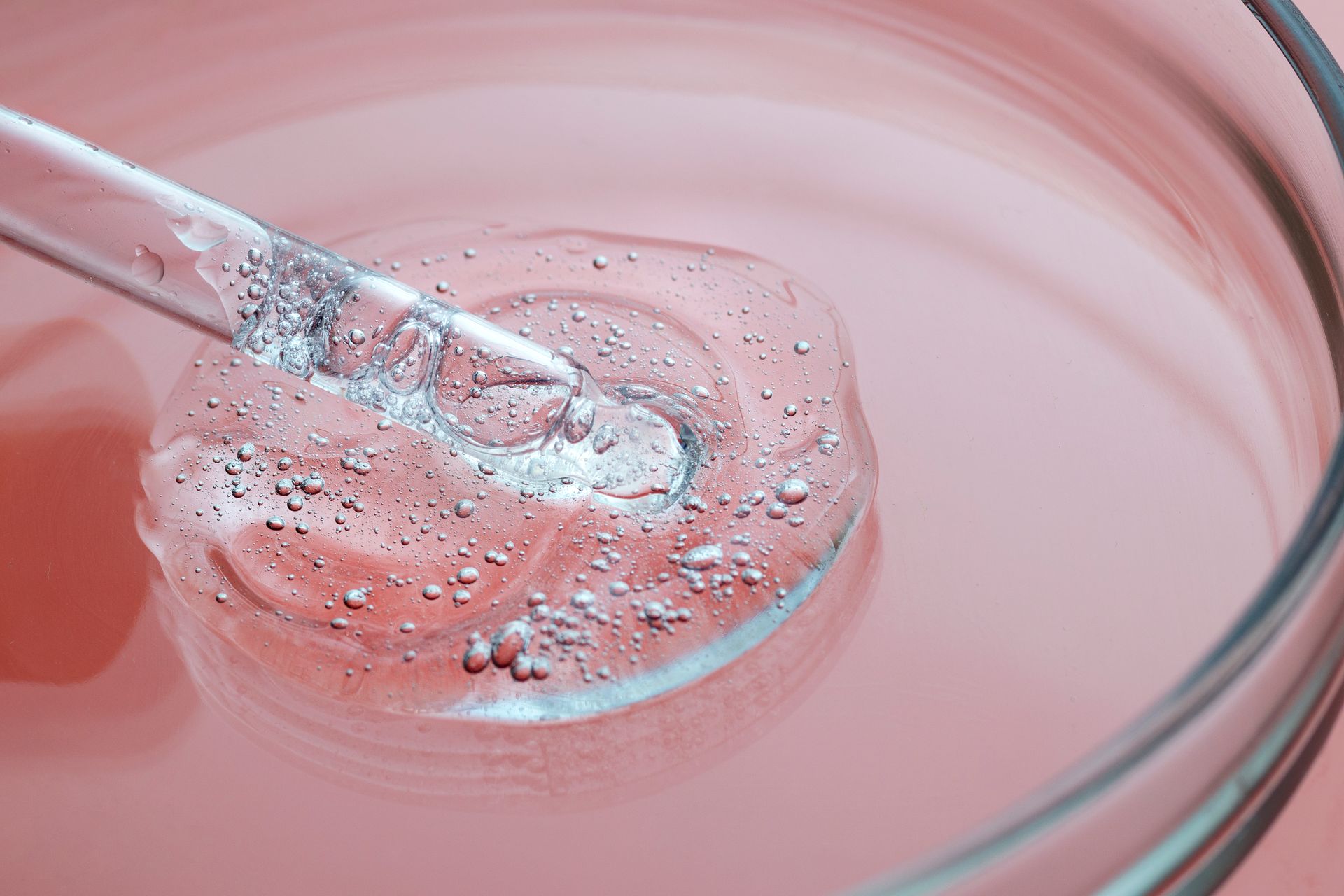 a close up of a pipette in a bowl of liquid .