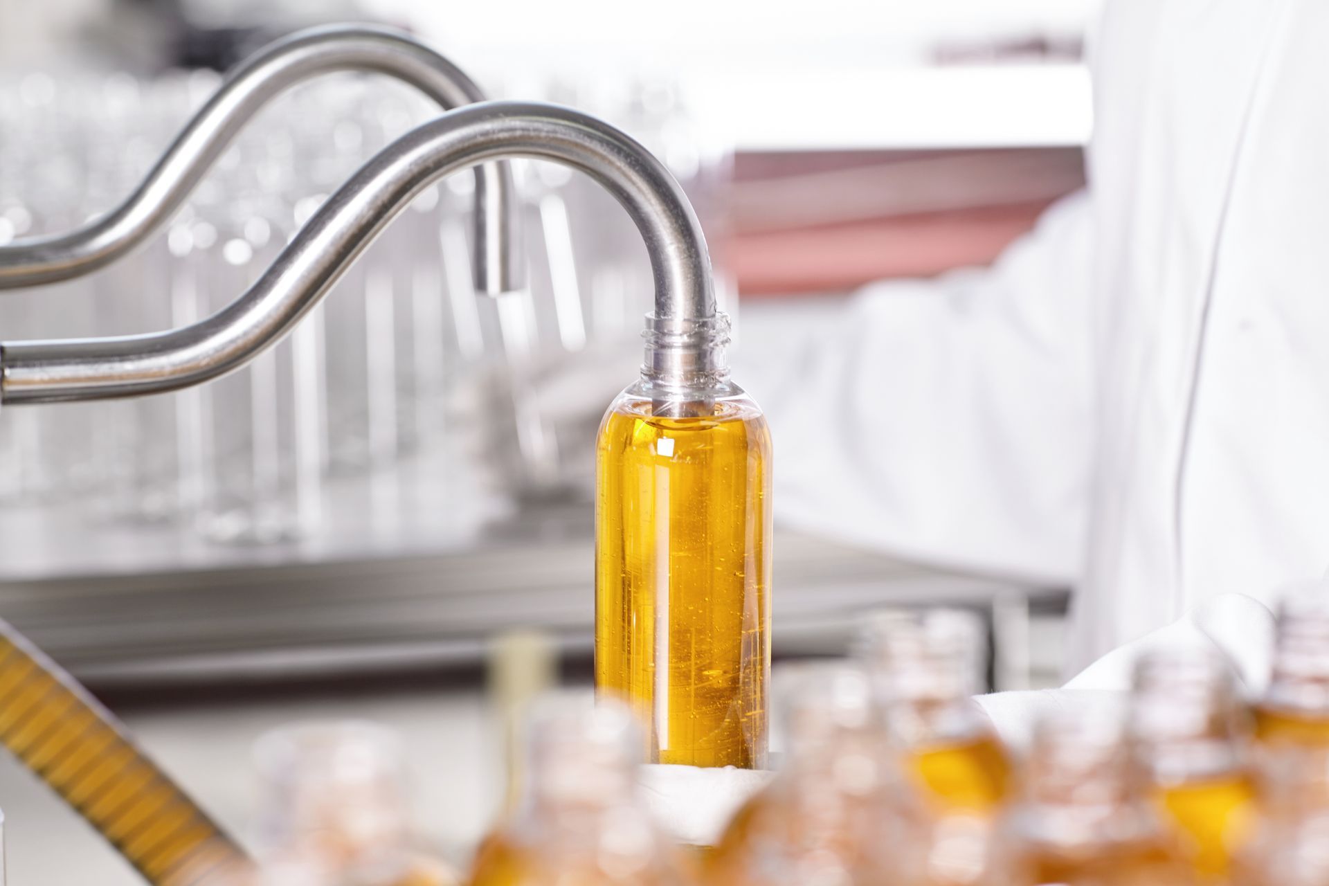 a bottle of liquid is being poured into a machine in a laboratory .