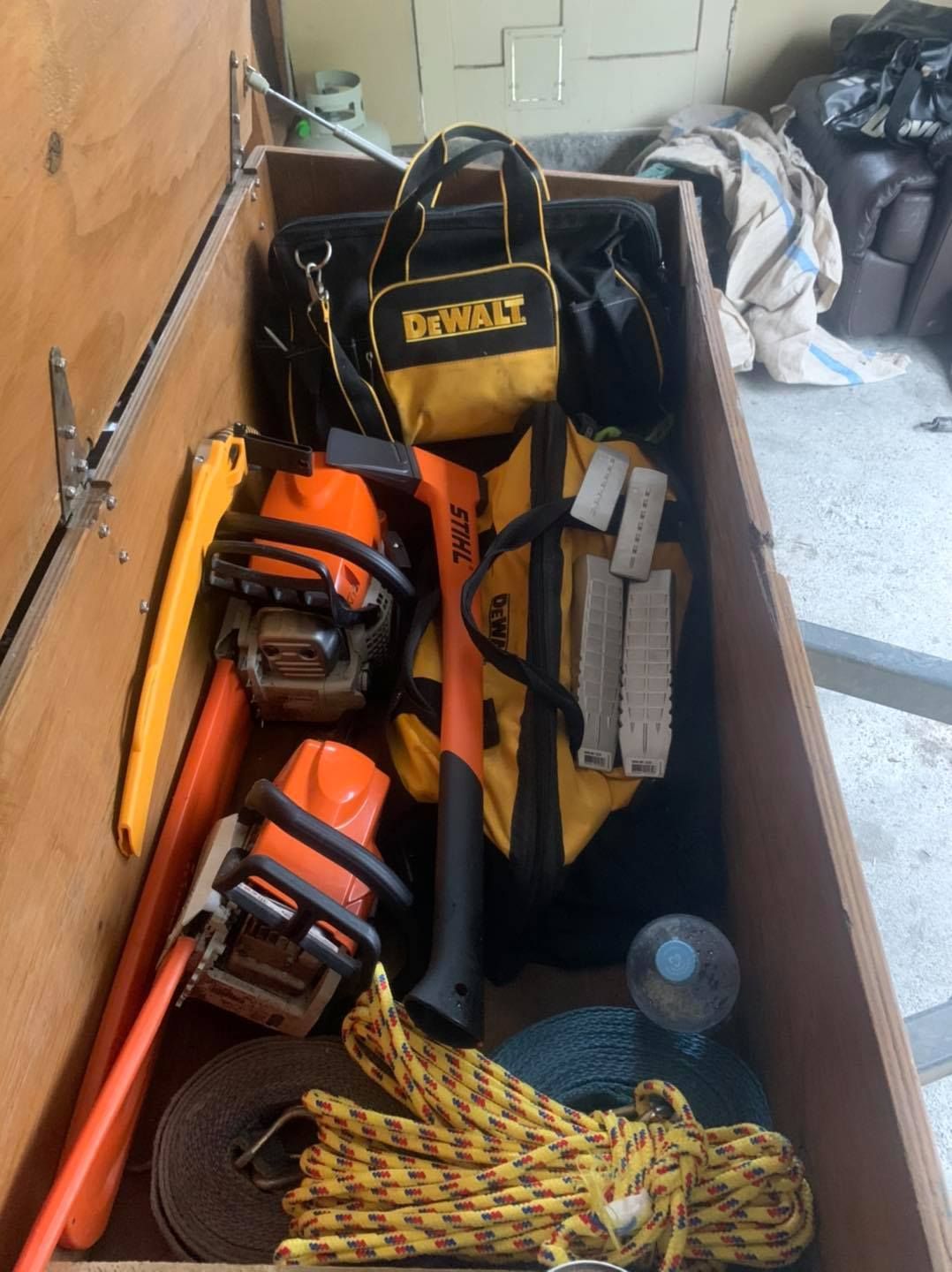 A wooden box filled with tools and a dewalt bag