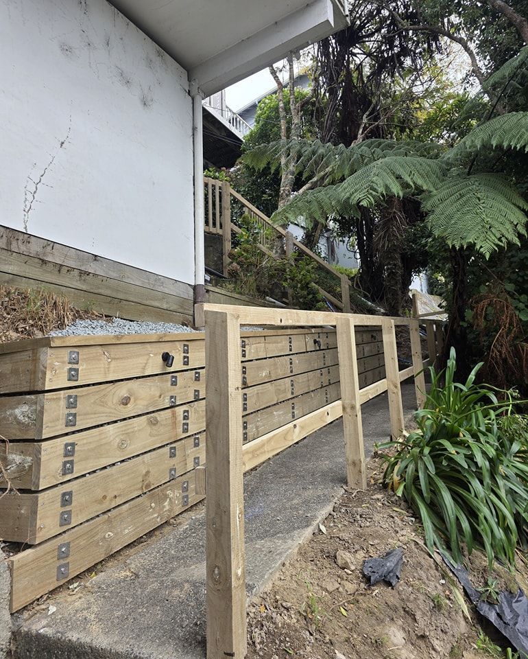 A wooden fence is being built next to a house.