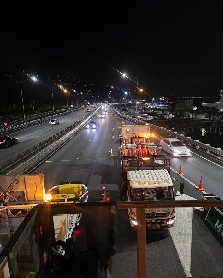 A highway at night with a lot of trucks on it