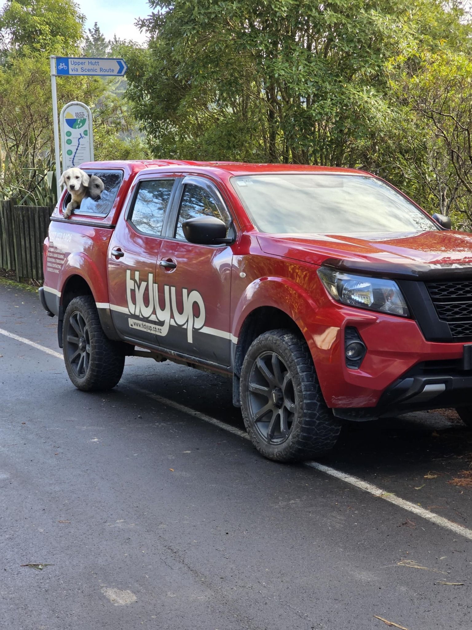 A red truck is parked on the side of the road.