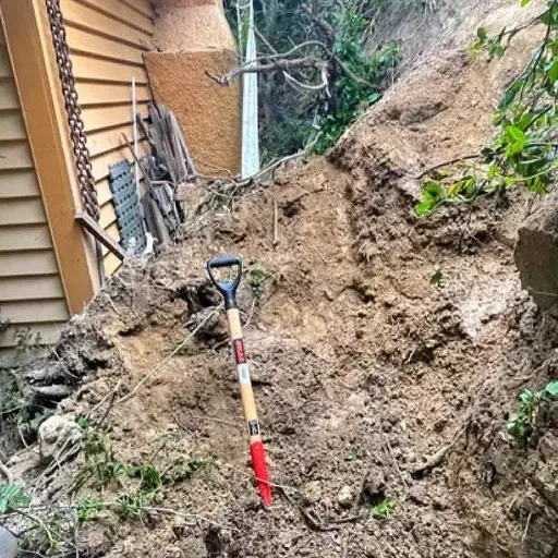 A shovel is sitting in the dirt next to a house.