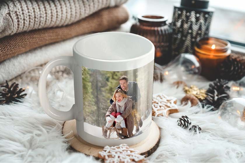 A white coffee mug with a picture of a man and a woman on it