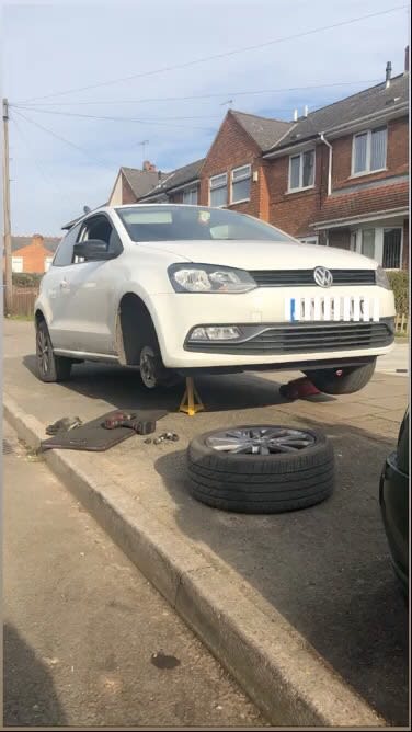 white car needing tyre change