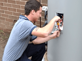 Electrician installing socket — Electricians Central Coast in Jilliby, NSW