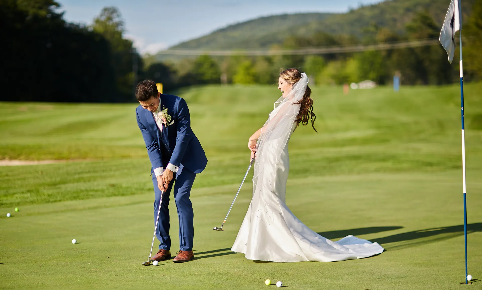 A bride and groom are playing golf on a golf course.