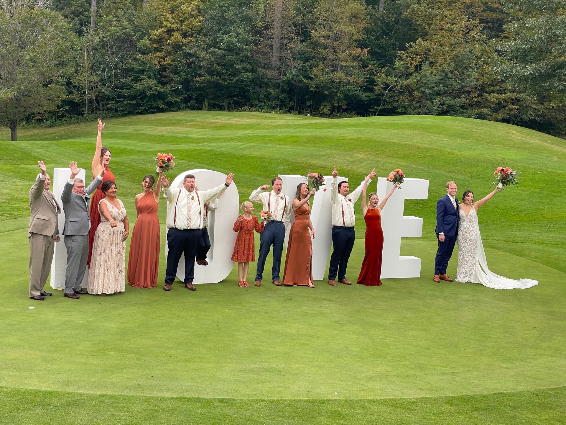 A group of people standing in front of a large sign that says `` home ''.