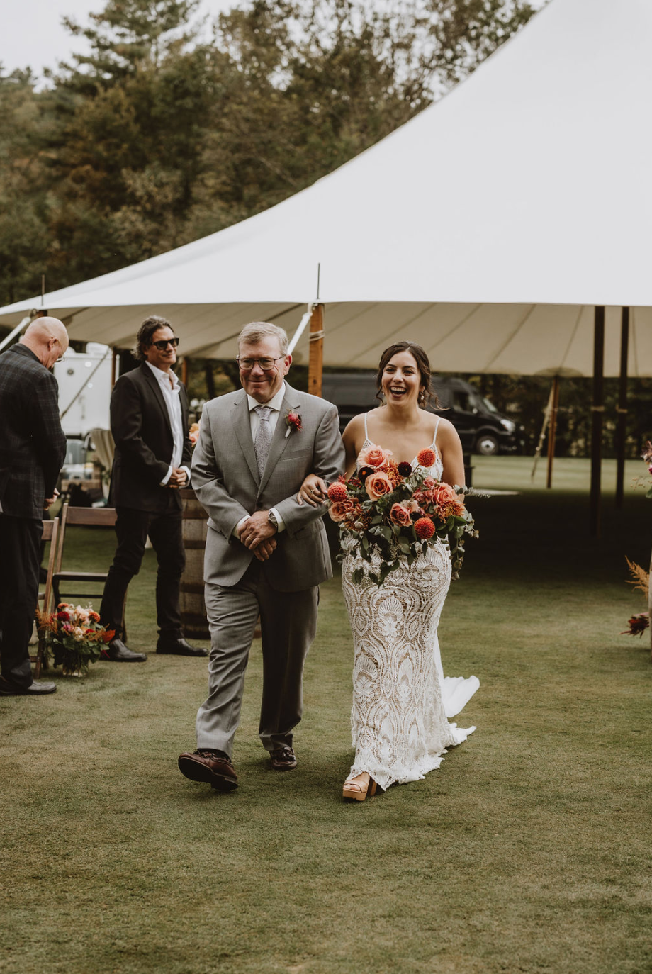 A bride and groom are walking down the aisle at their wedding.