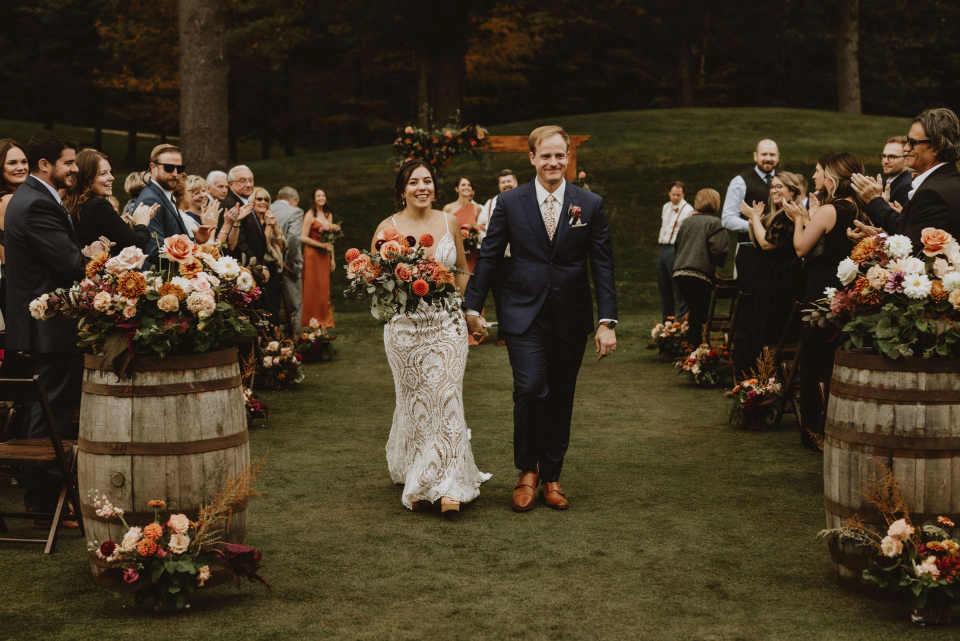A bride and groom are walking down the aisle at their wedding.