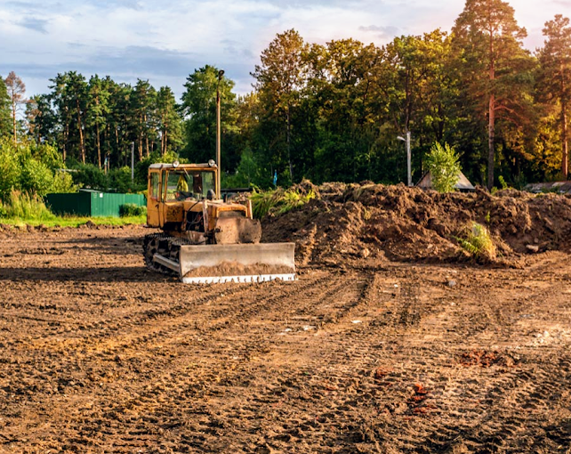 A bulldozer is moving dirt on a construction site.