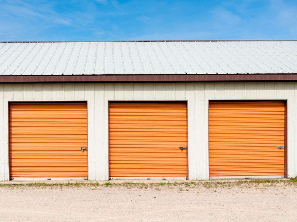 A Row Of Storage Units With Orange Doors And A White Roof — EasyLock Storage In  Southport, QLD