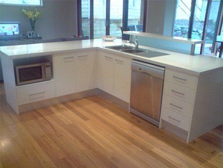 wooden flooring with nice white kitchen