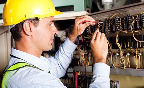 Professional Electrician — Electrician Working on a Circuit Board in Columbus, OH