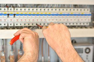 Columbus County Electrician — Electrician Connecting Up a Fuse Box in Columbus, OH
