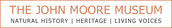 The John Moore Museum logo with text: Natural History | Heritage | Living Voices. Brown and white colors.