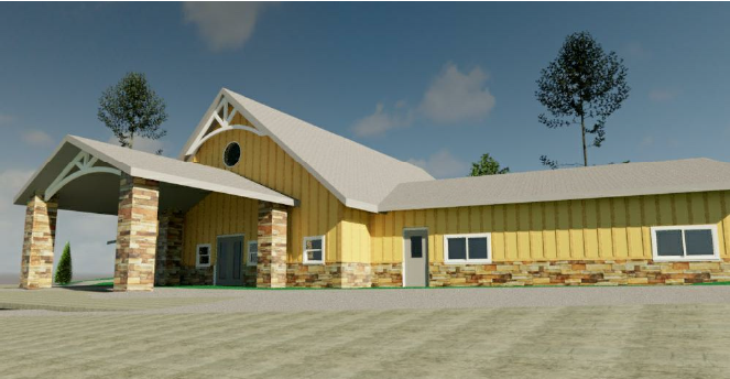 Yellow building with a covered entrance, stone accents, and a sloped metal roof under a blue sky