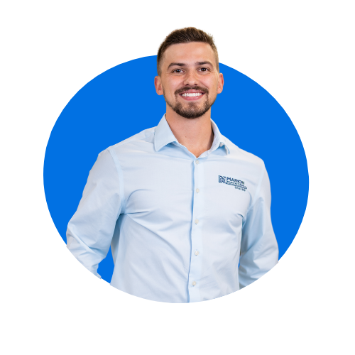 A man in a blue shirt is standing in a blue circle.