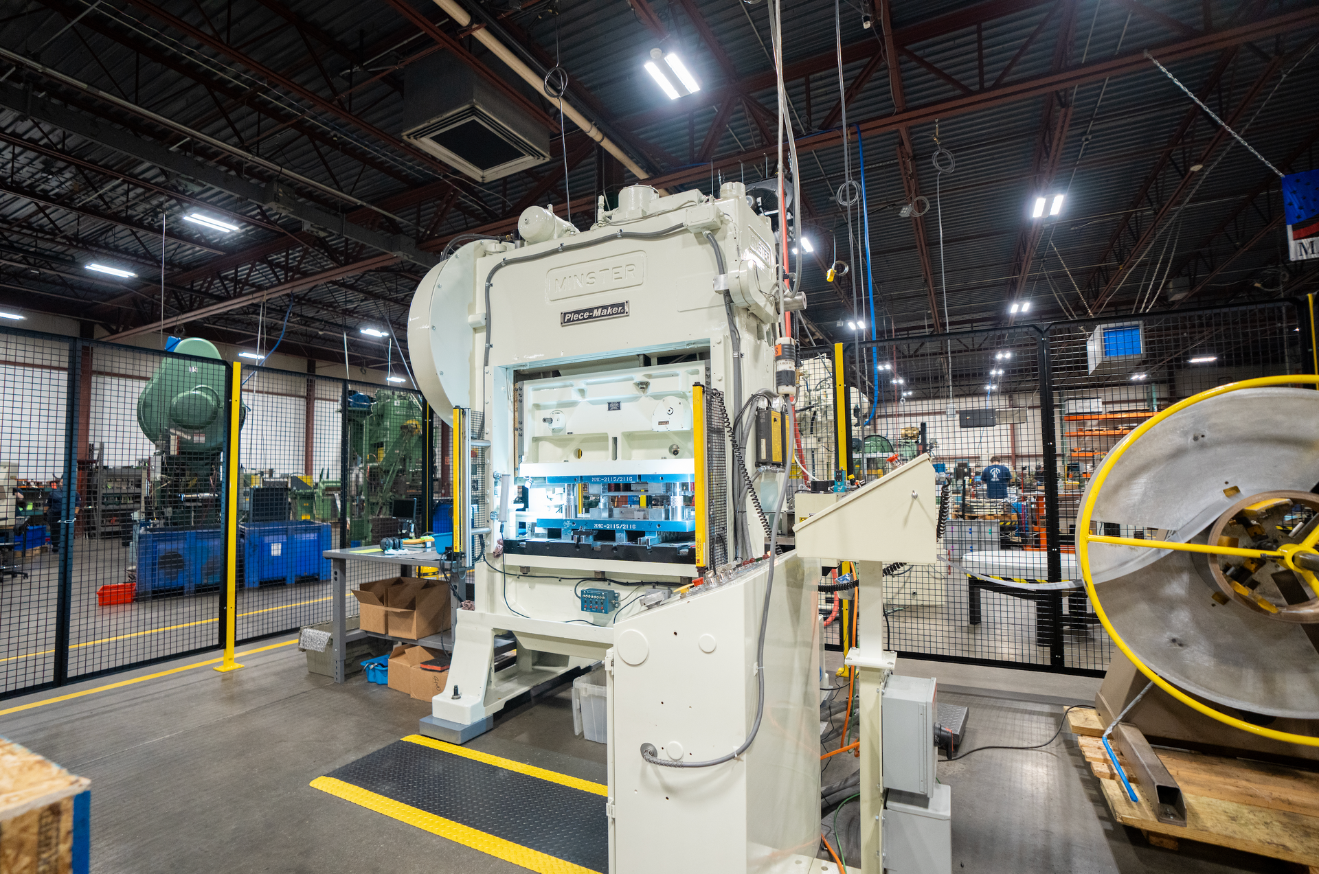 A large machine is sitting in the middle of a factory.