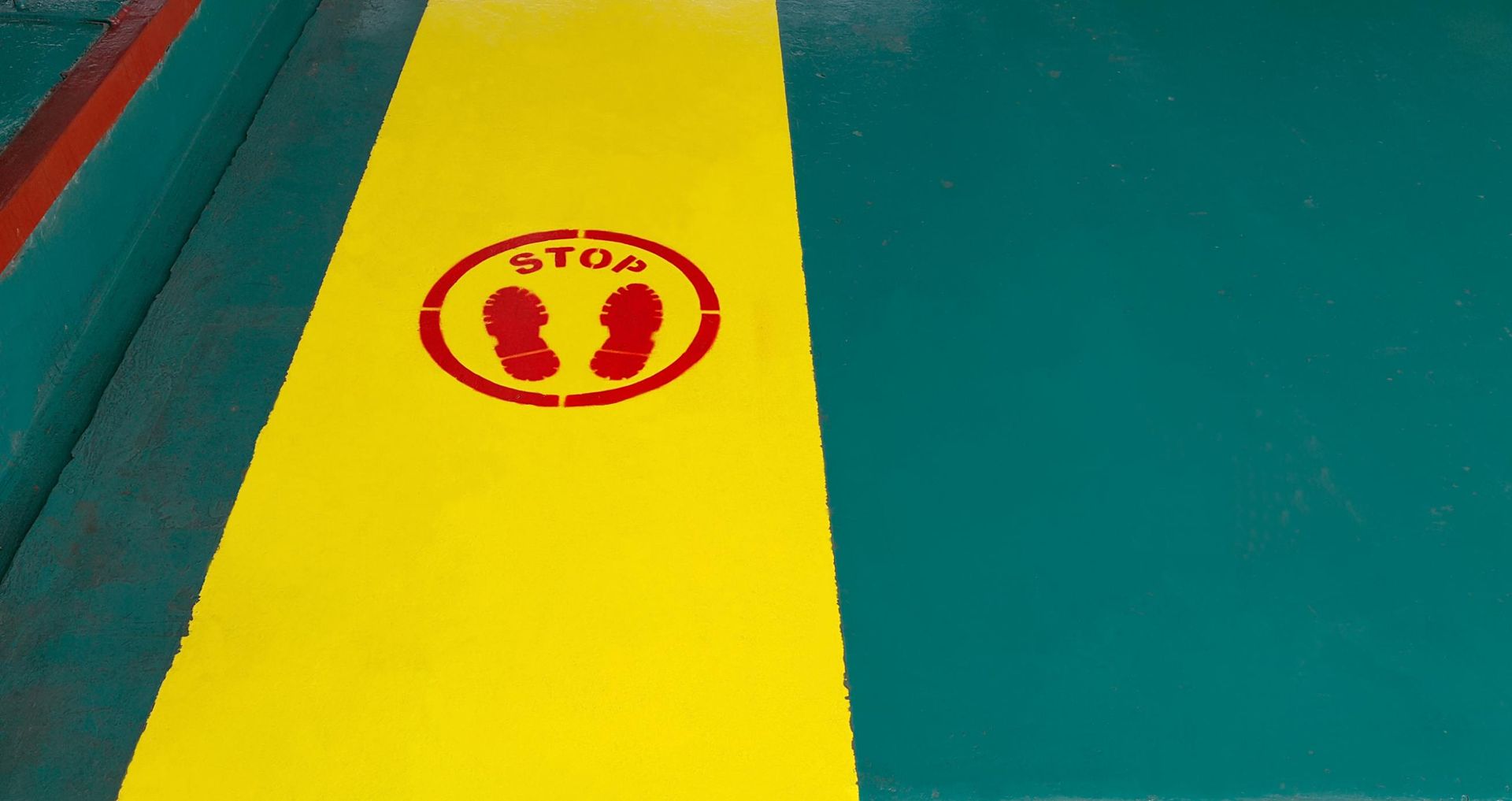 A Yellow and Green Striped Floor With a Stop Sign on It — North Coast Line Marking in Lismore, NSW
