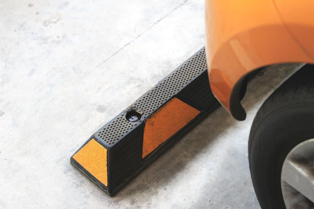 A Car is Parked on the Side of the Road Next to a Rubber Curb — North Coast Line Marking in Coffs Harbour, NSW