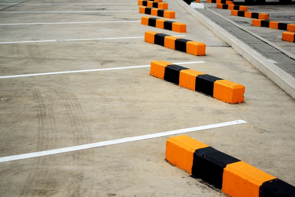A Row of Orange and Black Parking Blocks in a Parking Lot — North Coast Line Marking in Tweed Heads, NSW