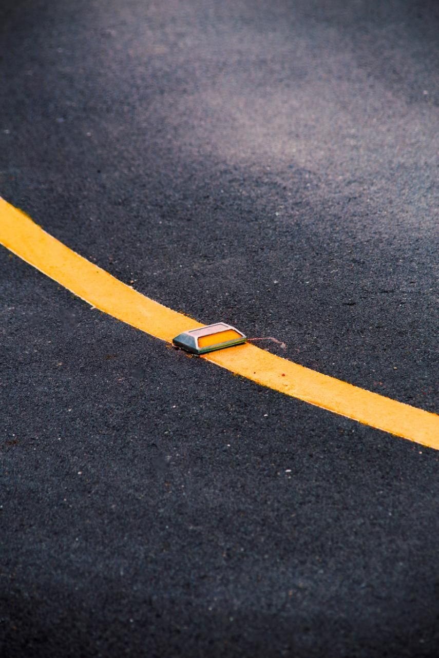 A Close Up of a Yellow Line on a Road — North Coast Line Marking in Gold Coast, NSW