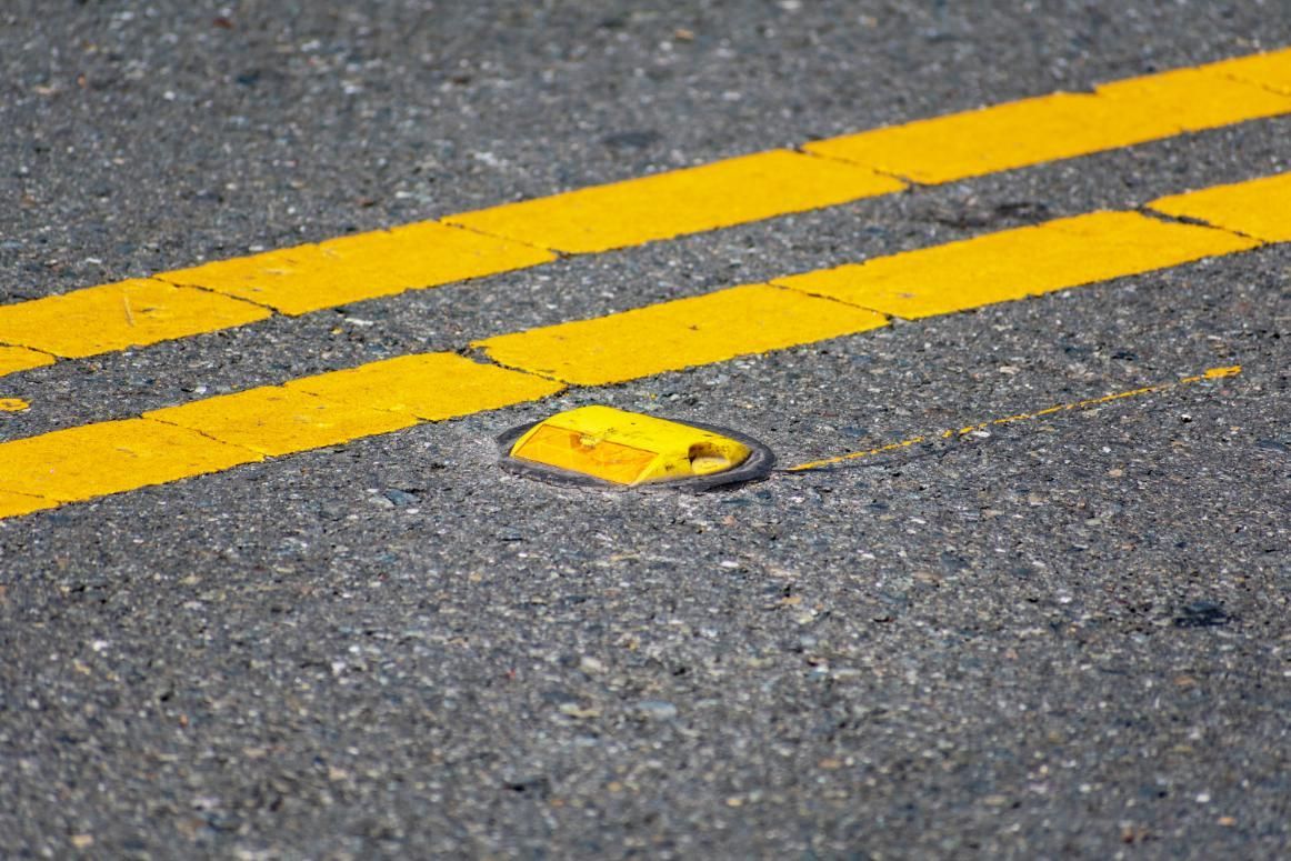 A Yellow Object is Sitting on the Side of a Road Next to a Yellow Line — North Coast Line Marking in Murwillumbah, NSW