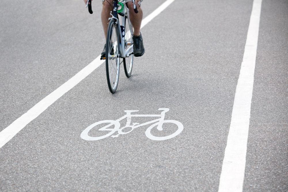 A Person is Riding a Bike on a Bike Lane — North Coast Line Marking in Talofa, NSW