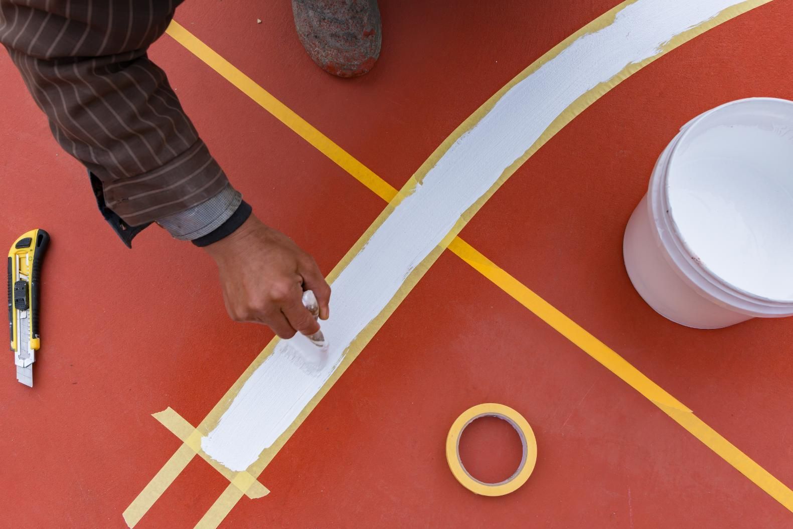 A Person is Painting a Line on a Basketball Court — North Coast Line Marking in Talofa, NSW